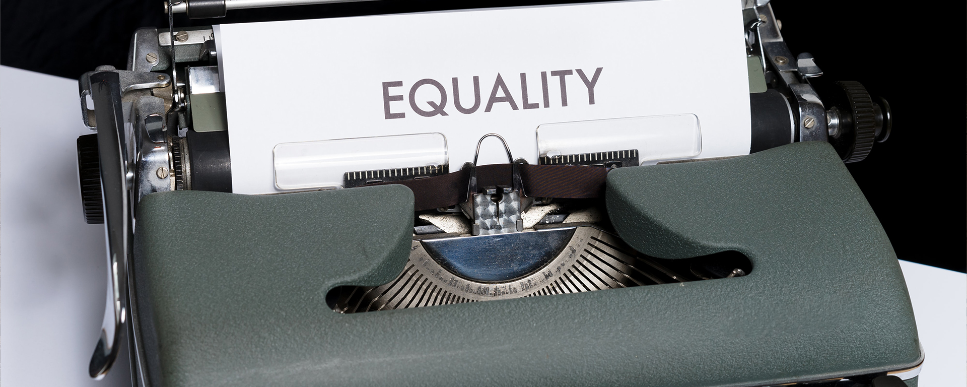 Typewriter with a piece of paper that says: EQUALITY