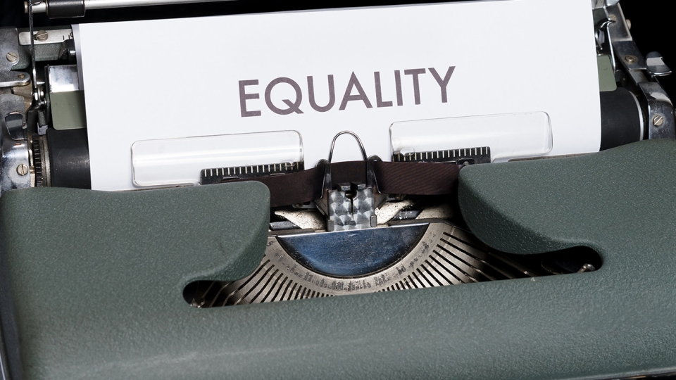 Typewriter with a piece of paper that says: EQUALITY