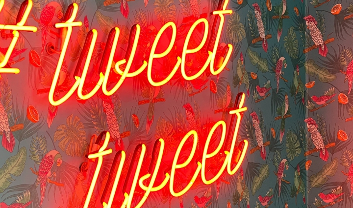 Neon sign that reads: #Tweet tweet