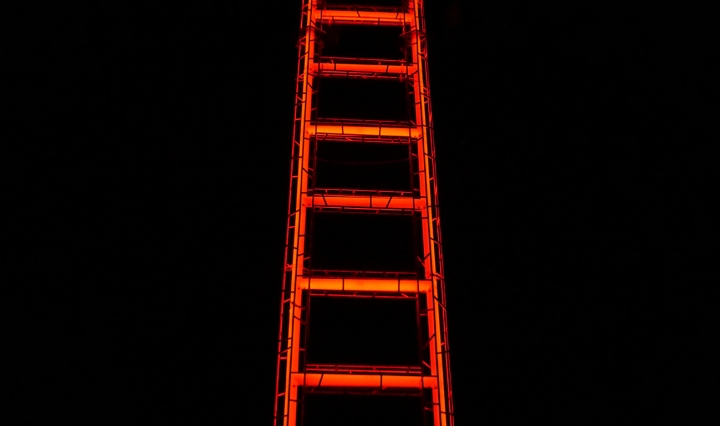 A neon ladder against a black background